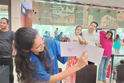 A MakerMasti host showing off a child’s finished artwork